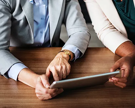 two people sat at tablet computer